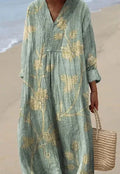 Long blue floral shirt dress with a 3D printed pattern, wide waist, and regular sleeves on a hanger.