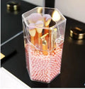 Transparent acrylic makeup brush storage bucket in white on bedroom table