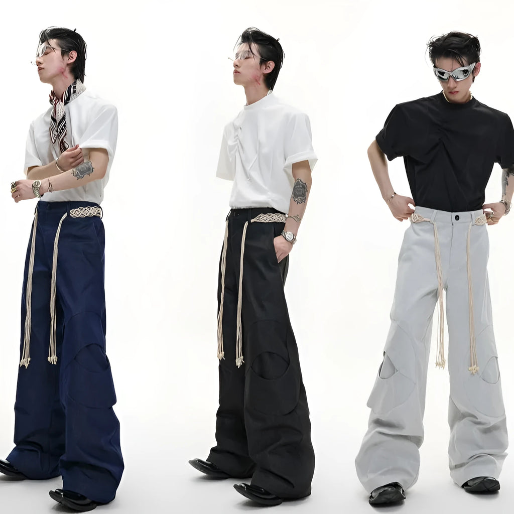 Men's dark blue straight-leg jeans with zipper decorations and tassel details on a loose cotton fit.
