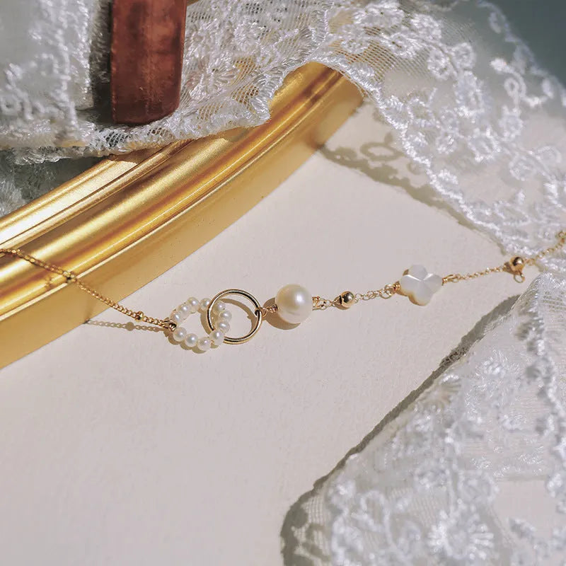 Natural pearl women's bracelet with a 14k gold-plated setting on a single strand.