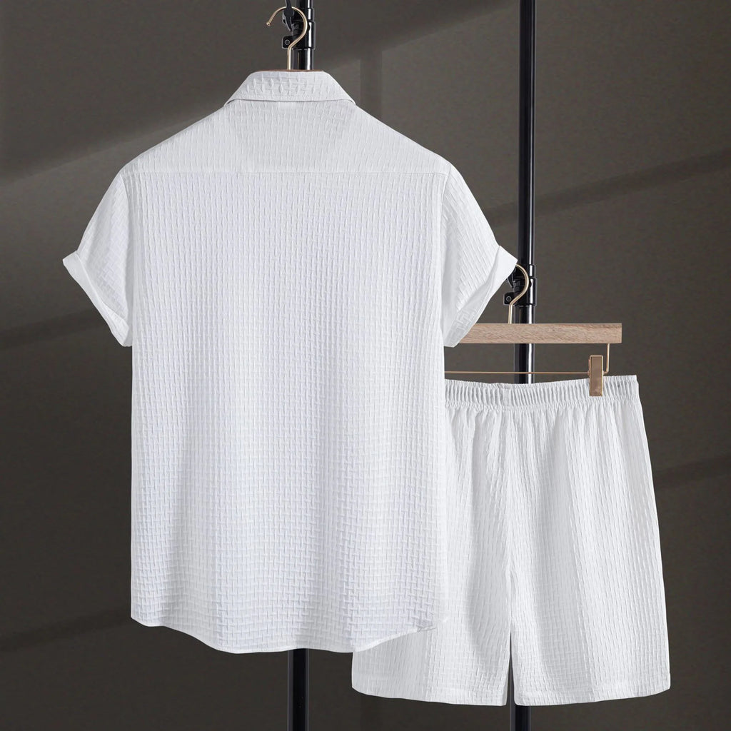 Men's white cotton blend beach suit with short sleeve shirt and loose-fitting shorts on a hanger.