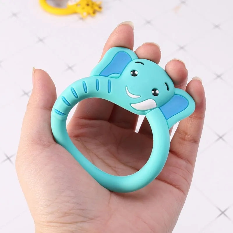 Three silicone baby molar teethers in brown, blue, and yellow on a white background