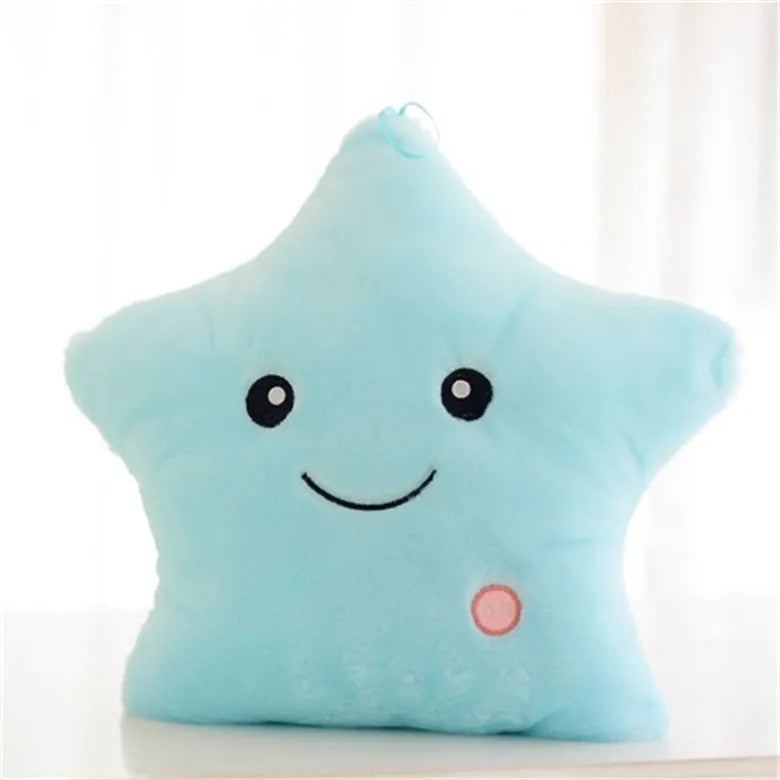 Colourful glowing five-pointed star plush pillow on a dark background, showing soft texture and LED illumination