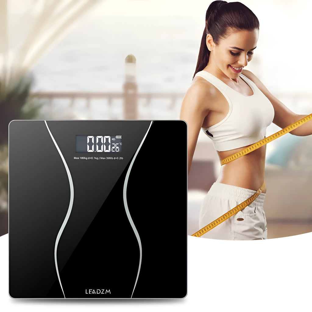 Black electronic digital bathroom scale with a 180kg capacity on a tiled floor.