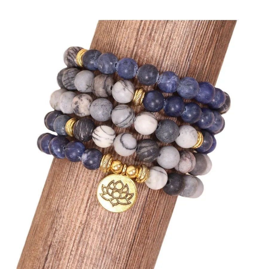 Blue multi-layer bracelet with patterned network stone beads on an alloy base.
