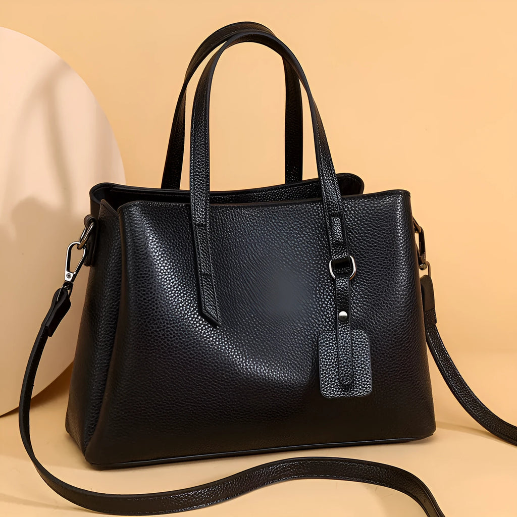 Women's cowhide leather large capacity handbag in horizontal square shape with single shoulder strap.