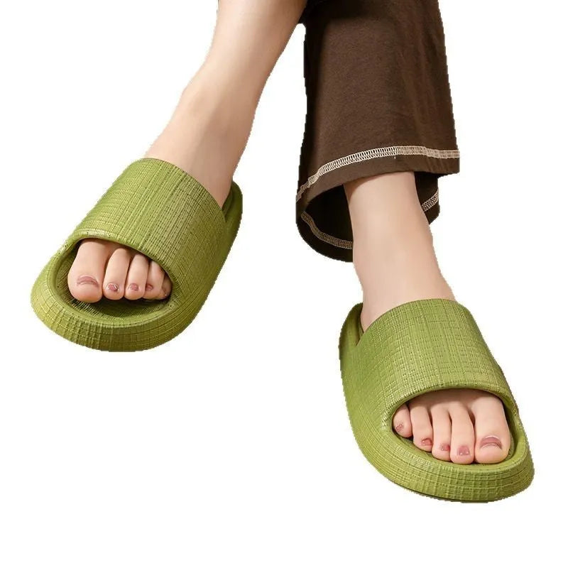 Pair of EVA toe ring flip flop slippers on a wet floor, showing non-slip sole pattern.