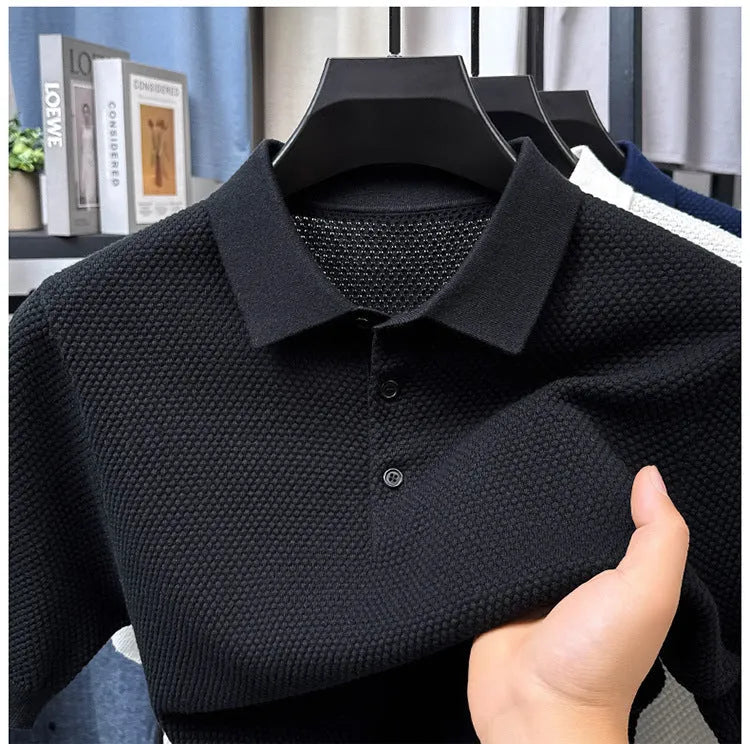 Man wearing a loose grey cotton short sleeve pullover sweater for casual leisure wear.
