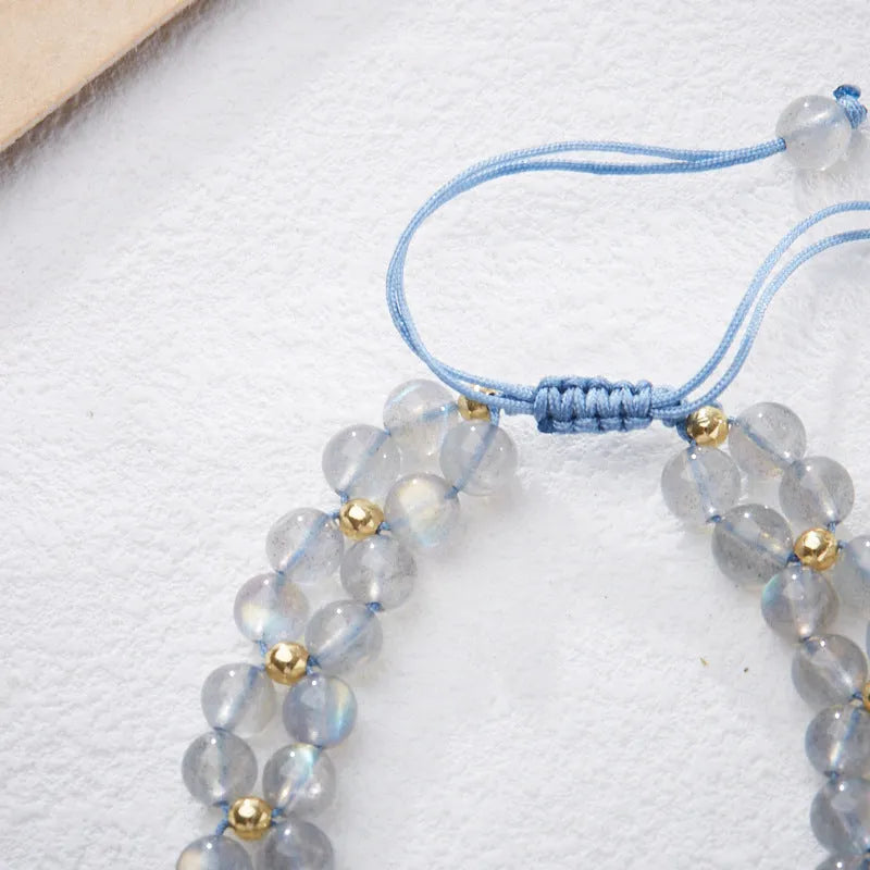 Grey moonstone butterfly charm on a handwoven cord bracelet for women.