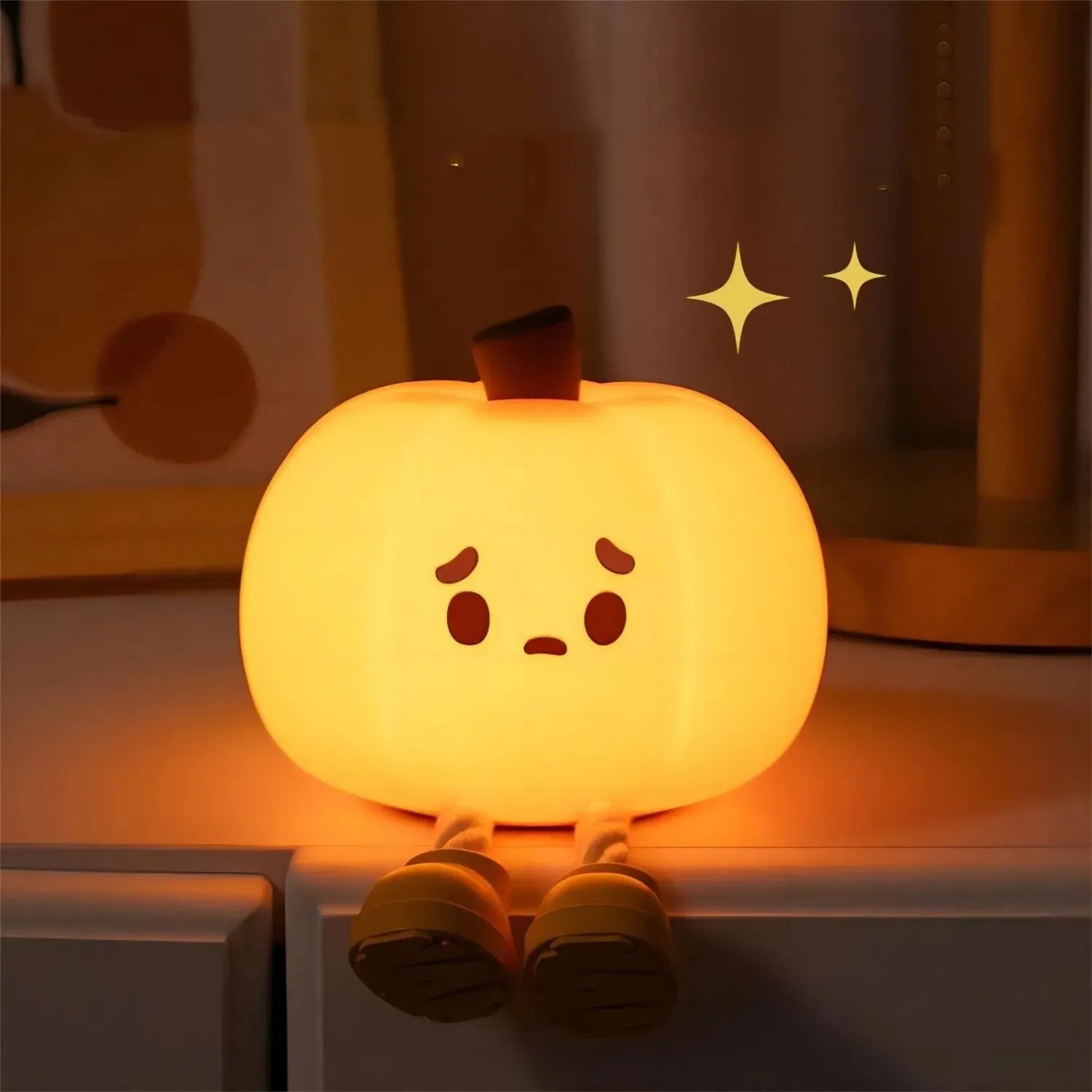 Soft silicone pumpkin-shaped night light with dimmable touch control on bedside table