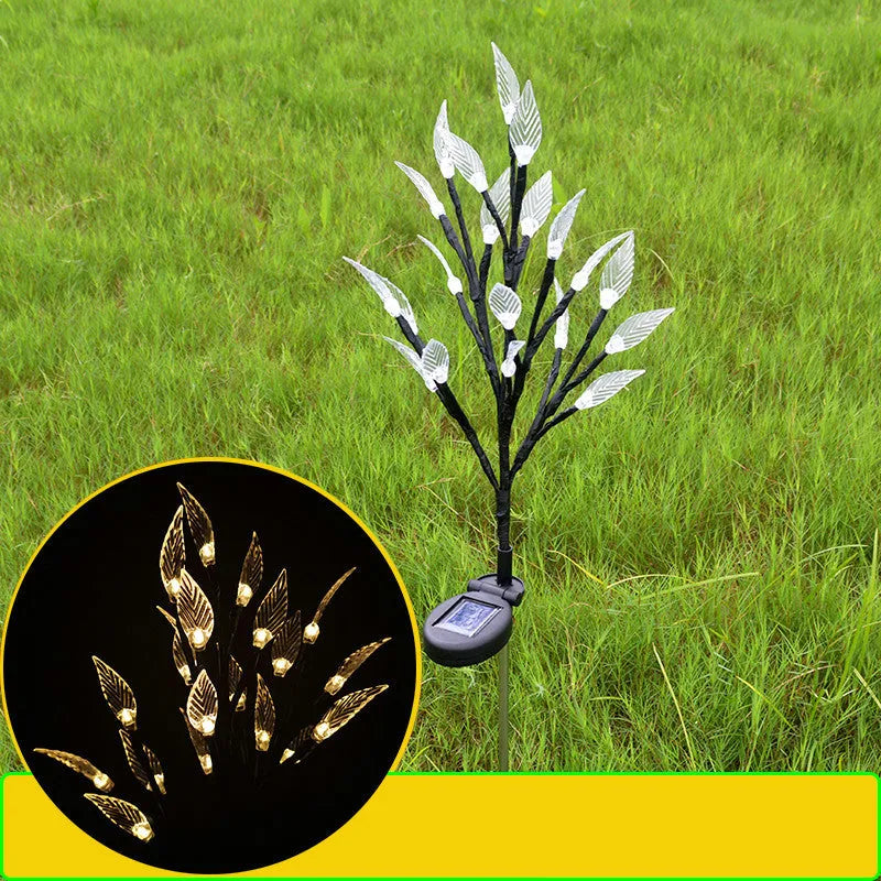 Three solar-powered garden lights with leaf branch design for lawn decoration