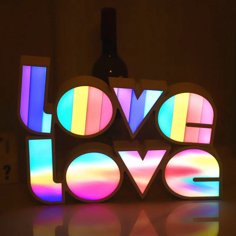 Rainbow style plastic LOVE LED decorative light on a surface.