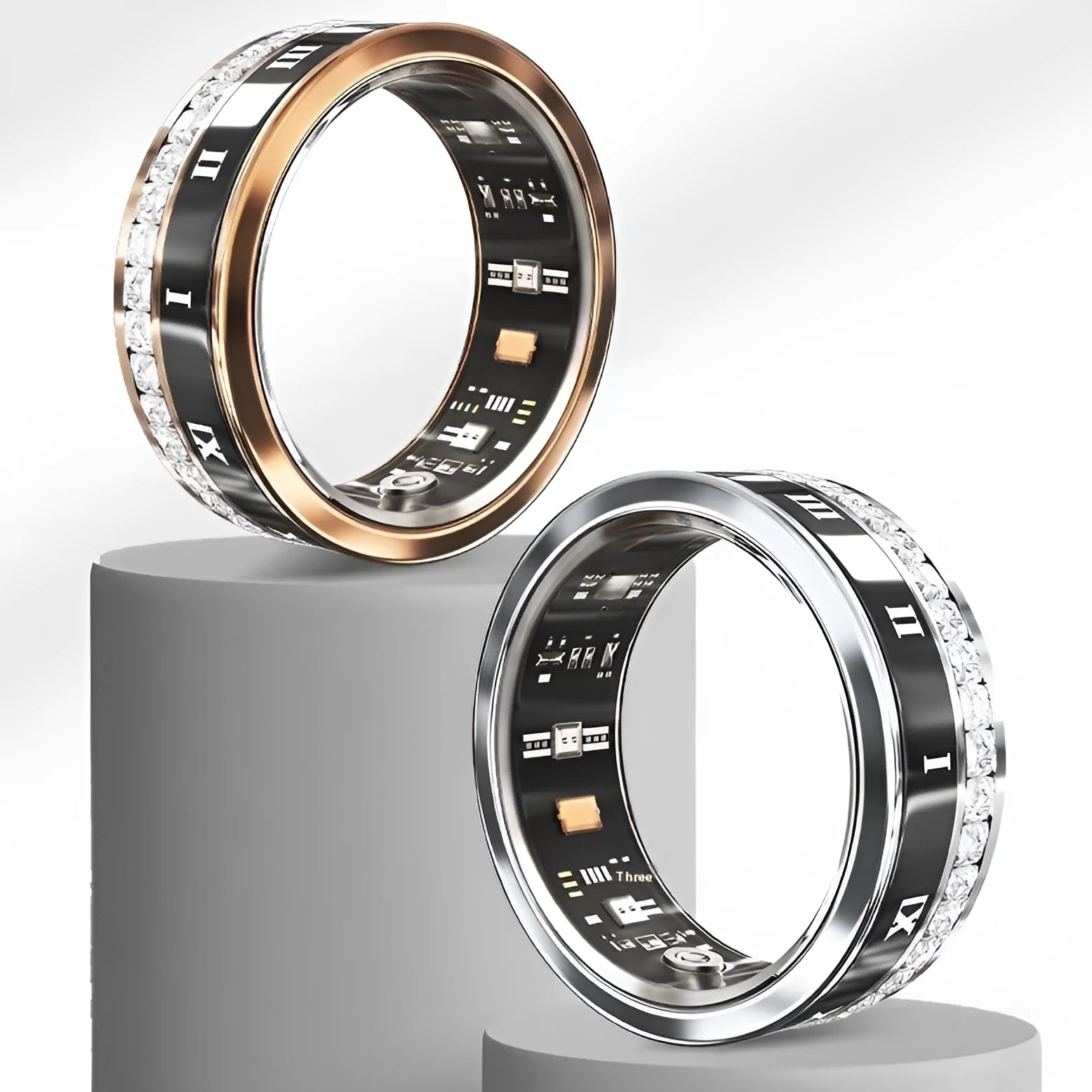 Diamond inlaid smart ring in silver and gold on finger, showing health tracking sensors.