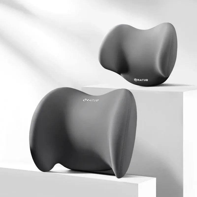 Grey geometric-patterned car headrest pillow and lumbar support cushion set on a car seat.