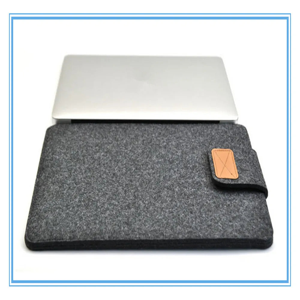 Dark gray felt laptop bag open showing plush lining and tablet compartment