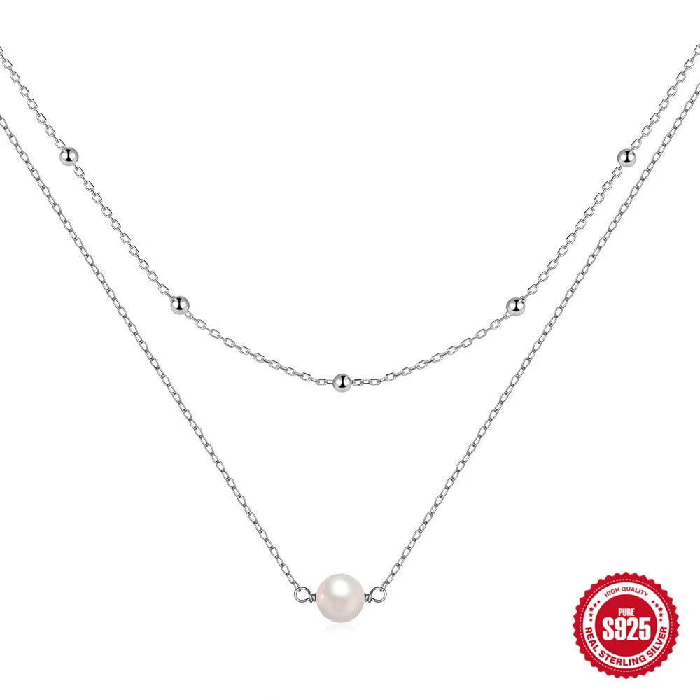 S925 Sterling silver double layer necklace with twin pearls on a ball bead chain, shown in gold and white gold colours.
