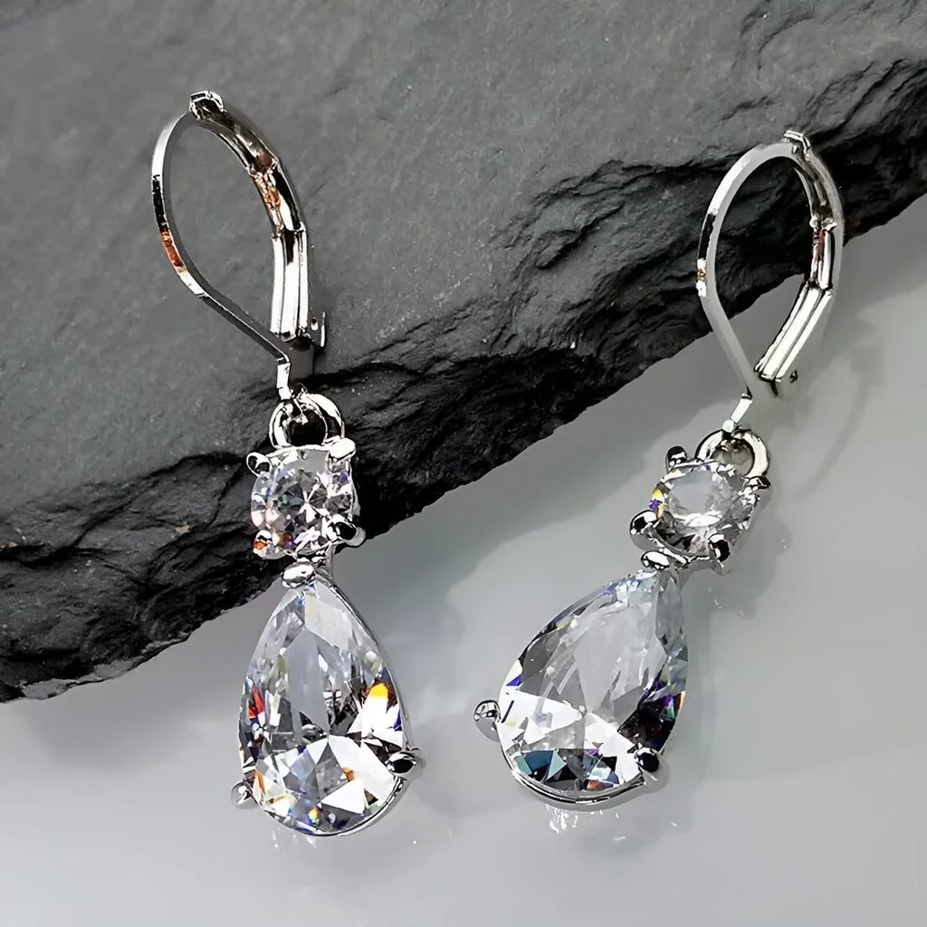 White gold drop-shaped long earrings with diamond finish on women