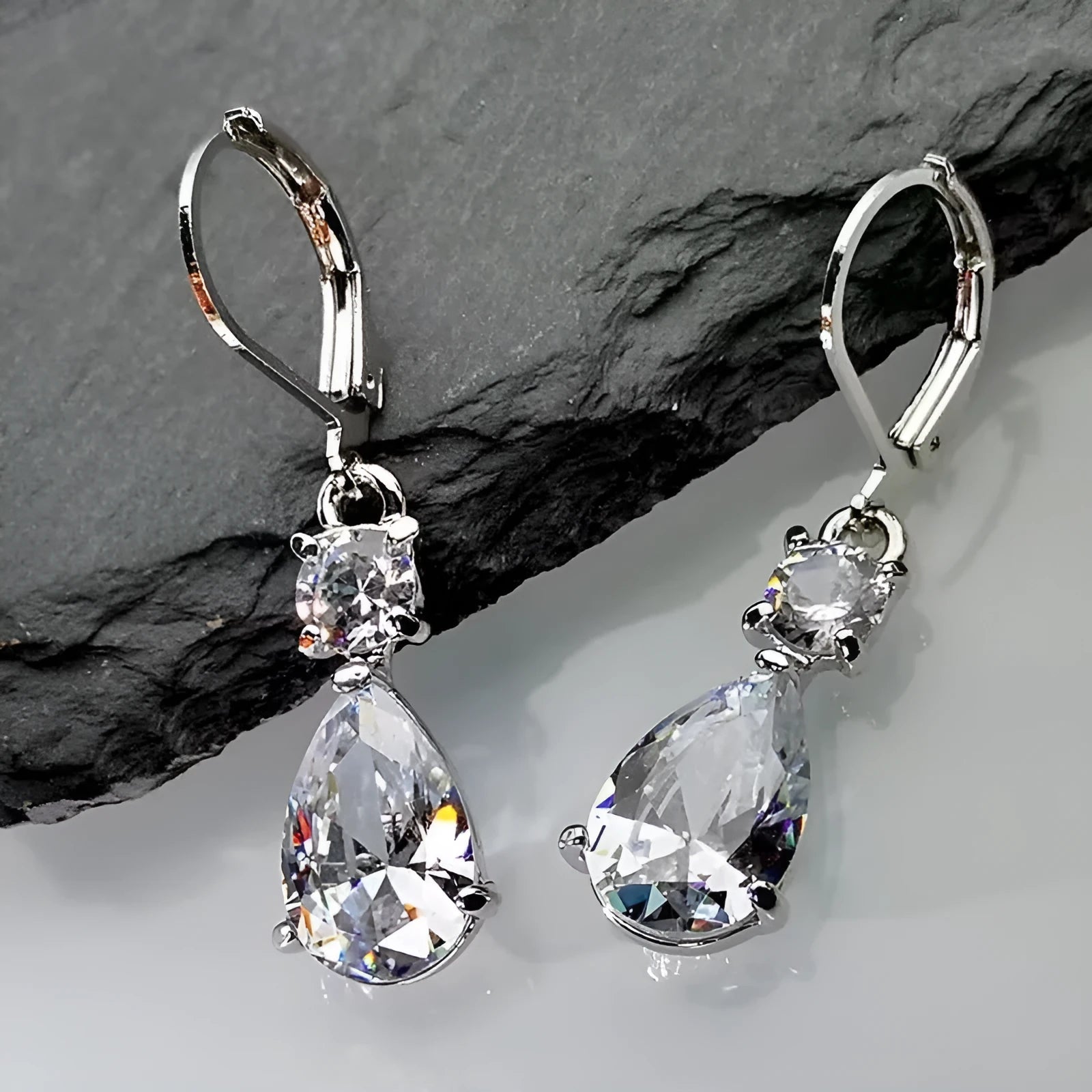 White gold drop-shaped long earrings with diamond finish on women