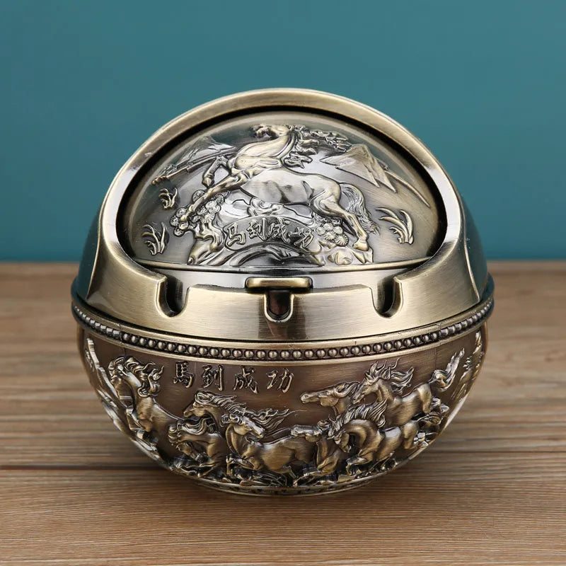 Bronze and red copper alloy decorative ashtray with smoke-extinguishing slot on a table.
