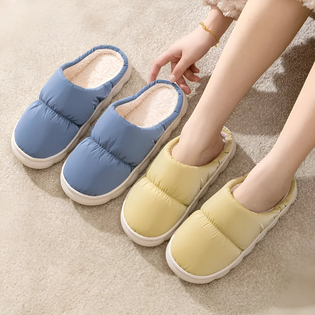 Blue down cotton winter slippers with thick rubber sole and plush lining for indoor use.