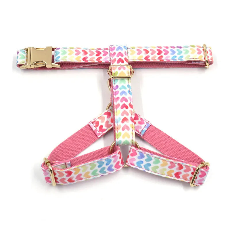 Pink dog harness with gold buckle and colourful heart-shaped stone decoration in four adjustable sizes