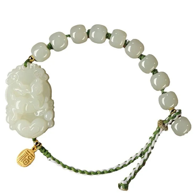 Close-up of a Rabbit zodiac charm Hetian jade bracelet with red rope and S925 silver card.