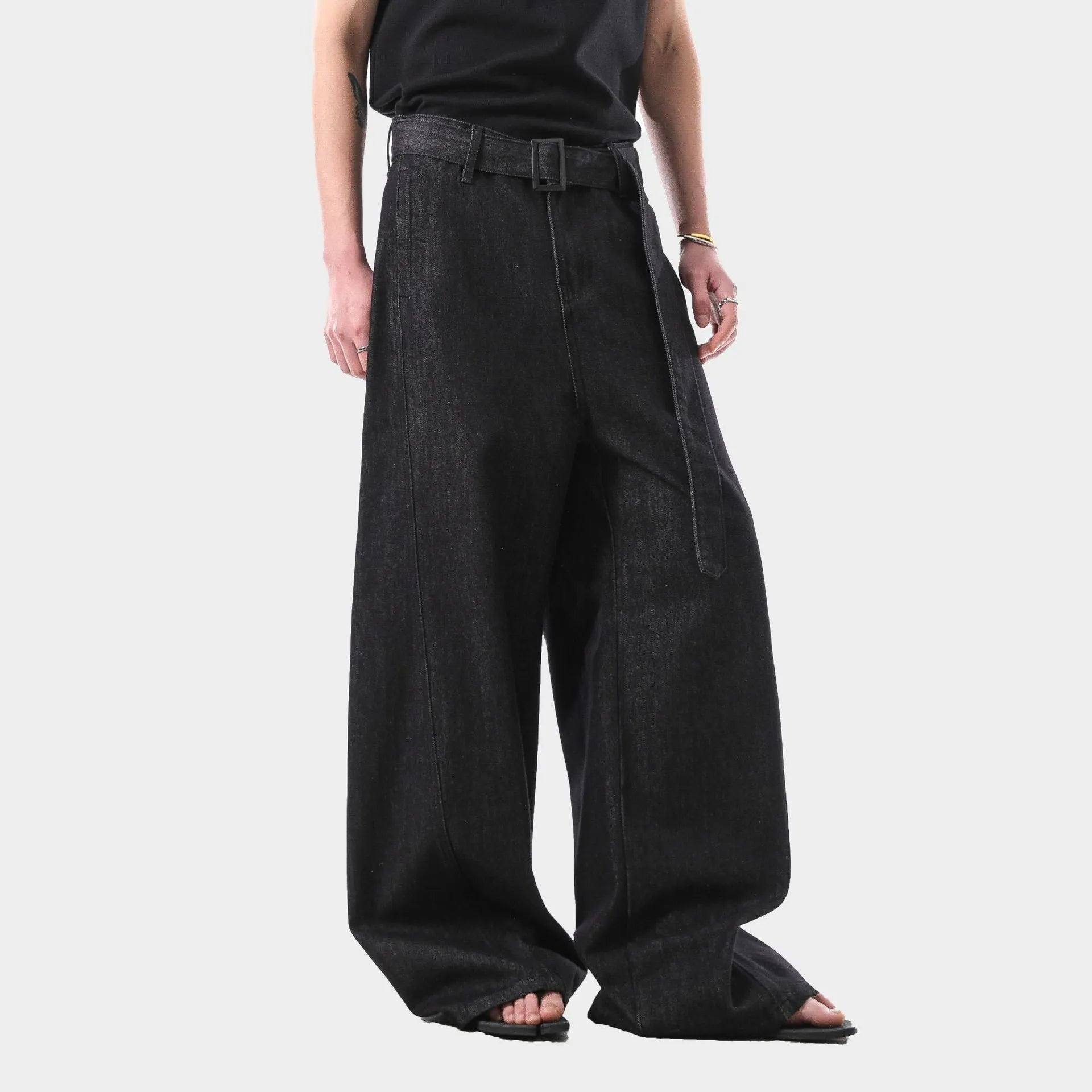 Black high-waist straight-leg jeans with gold contrast stitching on a flat lay.