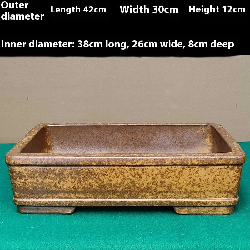 Straight-sided shallow rectangular Yixing purple Zisha clay flowerpot on a wooden surface.