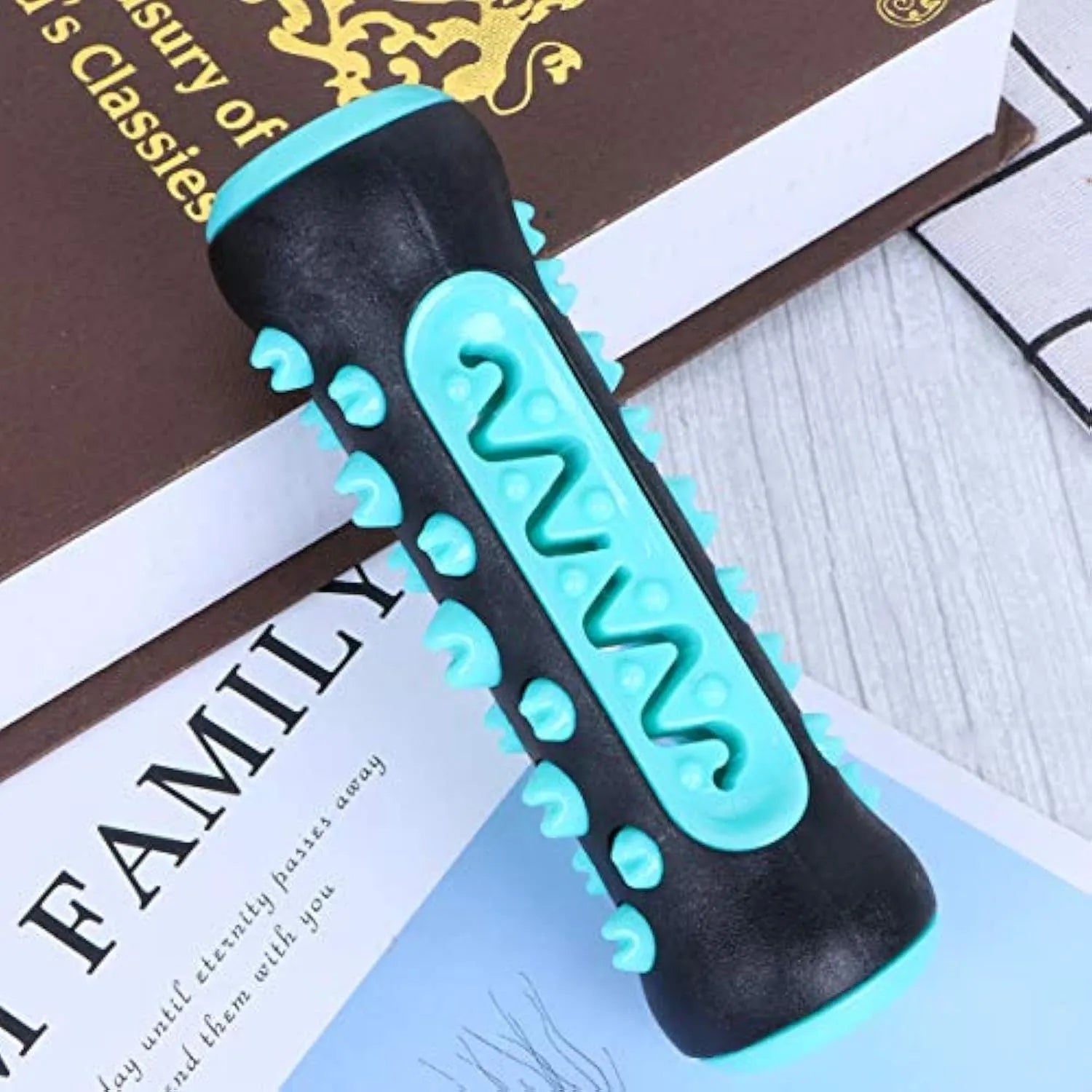 Natural rubber dog dental chew toy in blue, shown as a toothbrush-shaped stick for teeth cleaning.