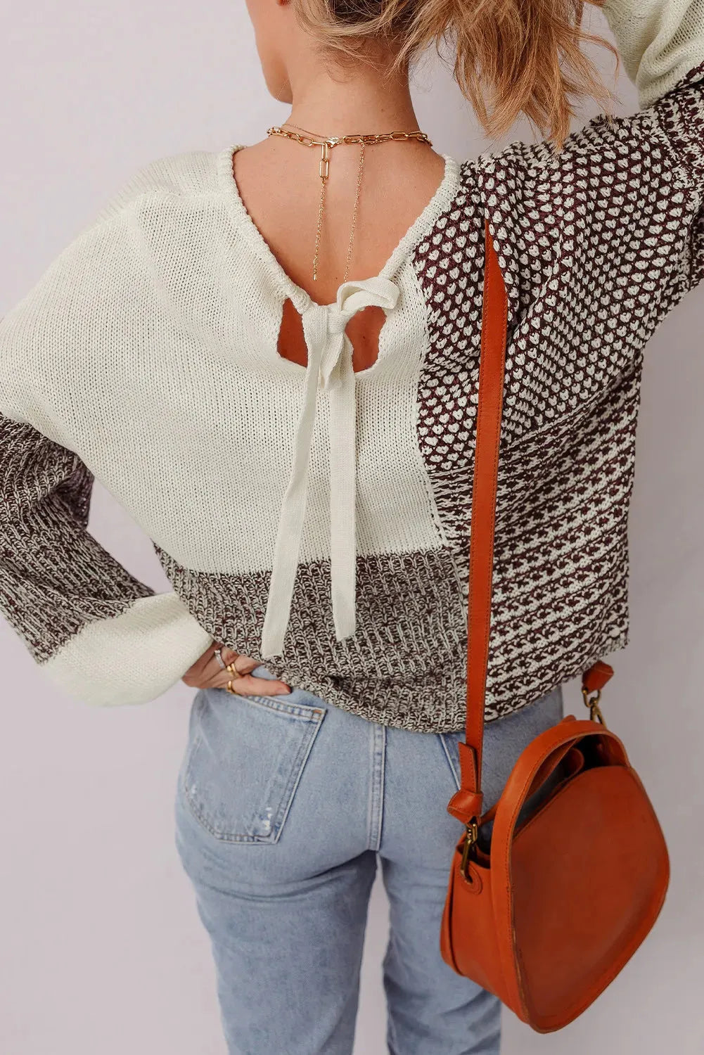 Dark khaki loose drop shoulder sweater with a colour block back panel and tie detail.
