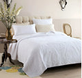 Three-piece pure cotton quilted bed cover set in white with Nordic floral embroidery on a 1.8m bed