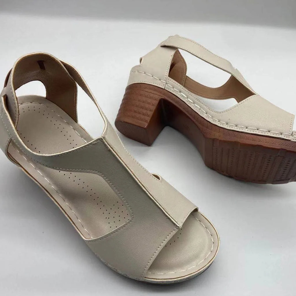 Women's low heel peep toe wedge sandals with a Roman style buckle strap in light brown.