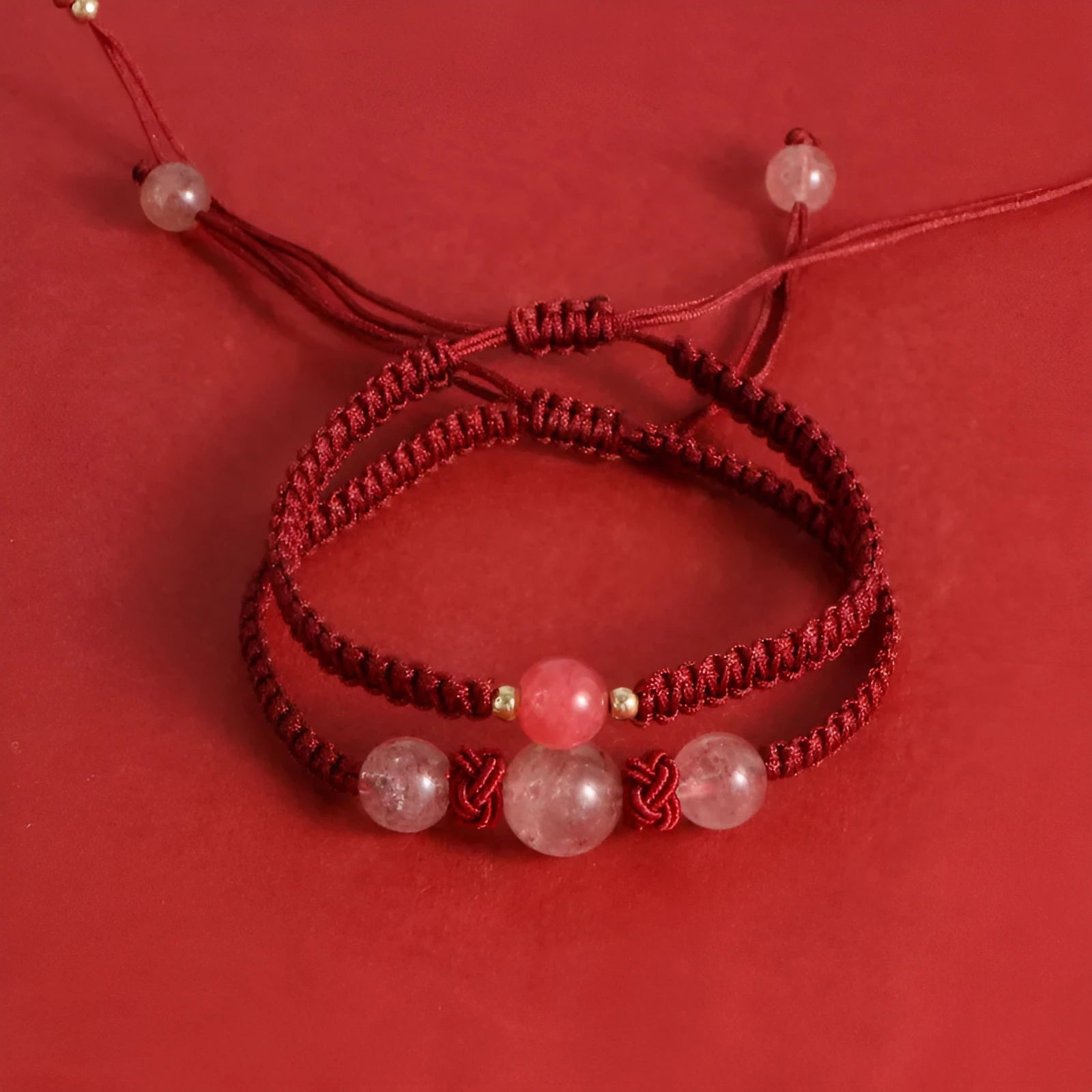 Red woven rope bracelet with spherical strawberry quartz beads and alloy accents