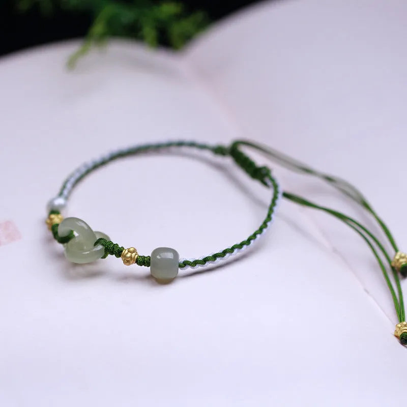 Natural Hetian jade pendant on woven wire bracelet with hollow-out design