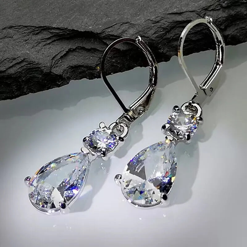 White gold drop-shaped long earrings with diamond finish on women