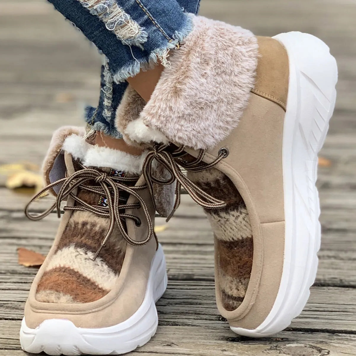Women's beige lace-up suede snow boots with fuzzy lining and a thick non-slip rubber sole.
