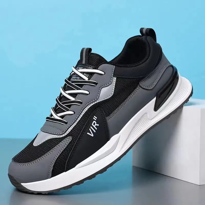 Men's black and grey colour block mesh running shoes with white soles on a plain background.