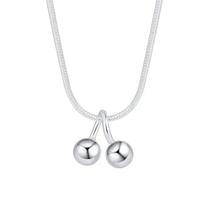Silver cherry pendant necklace on a snake bones chain, adjustable from 21cm to 50cm length.