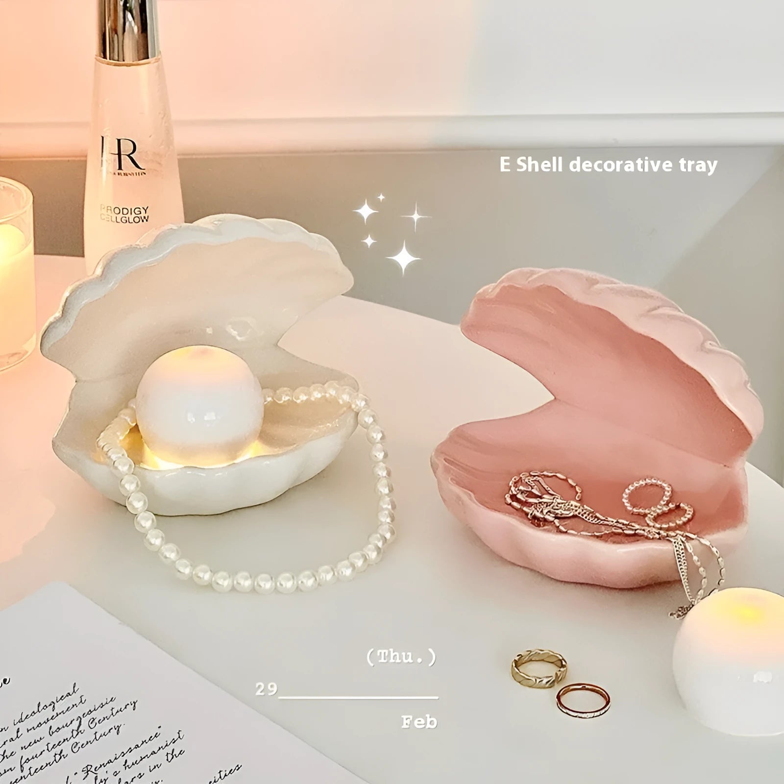 White porcelain decorative shell-shaped tray with a matching small night lamp on a wooden surface.