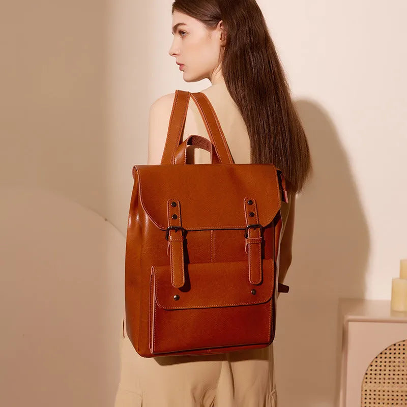 Black genuine cowhide leather computer backpack for women with hard construction.