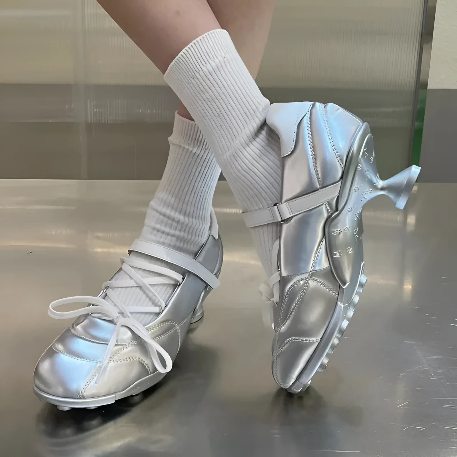 Women's silver low-top sports shoes with lace-up bow and a short stout heel on a viscose sole.