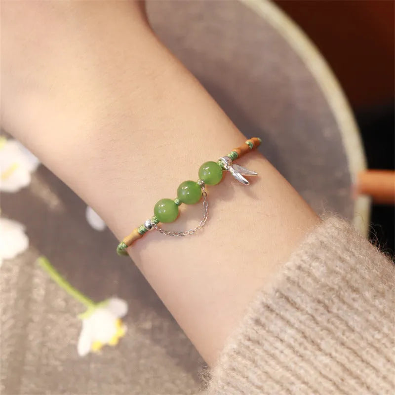 Hetian jade diamond-shaped bracelet with lotus seedpod design and woven carrying strap in light green or haze blue colour options
