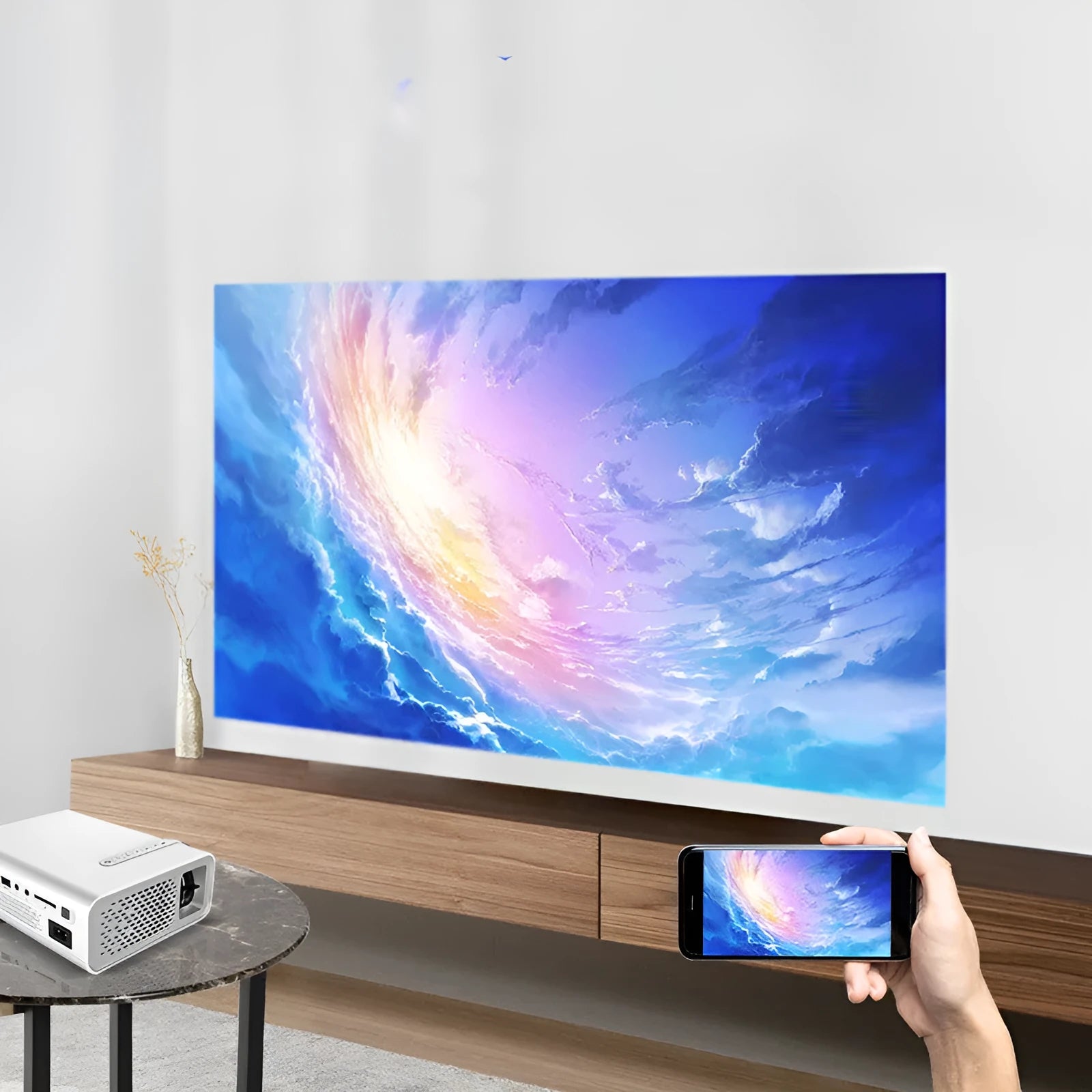 Black YG530 mini mobile phone projector on table projecting image on wall