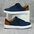 Beige brown platform skateboard sneakers with a cross-strap and round toe on a white background.
