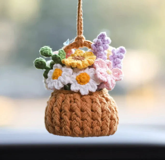 Green and white knitted wool car plant decoration with basin base and hanging rope