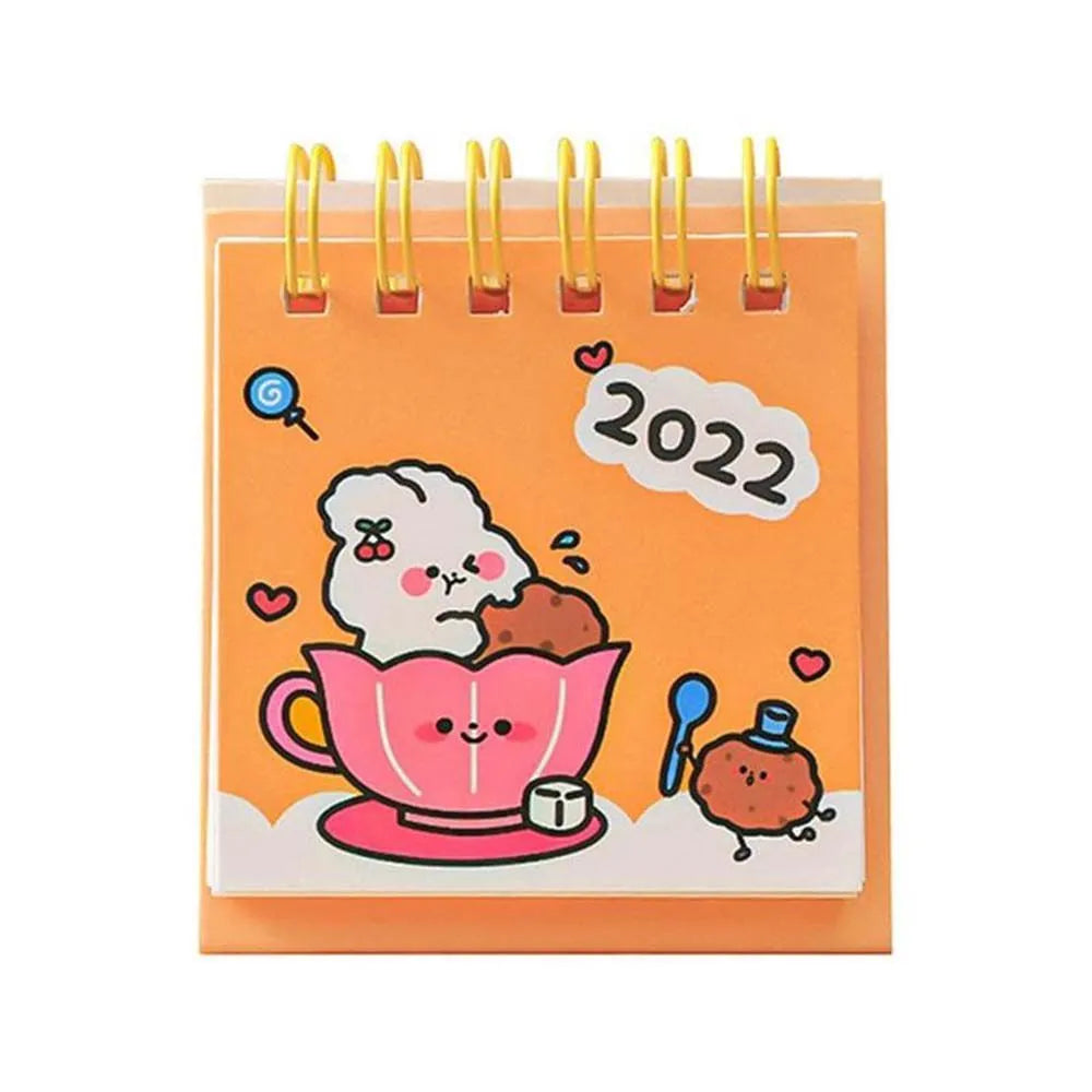 Mini desk calendar with cartoon design showing 9.3cm x 6.4cm paper calendar on a table