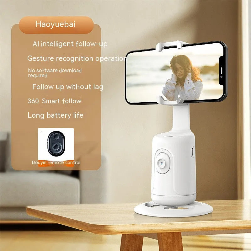 Automatic tracking stabiliser with 360-degree rotation in black, pink, and white on a desktop