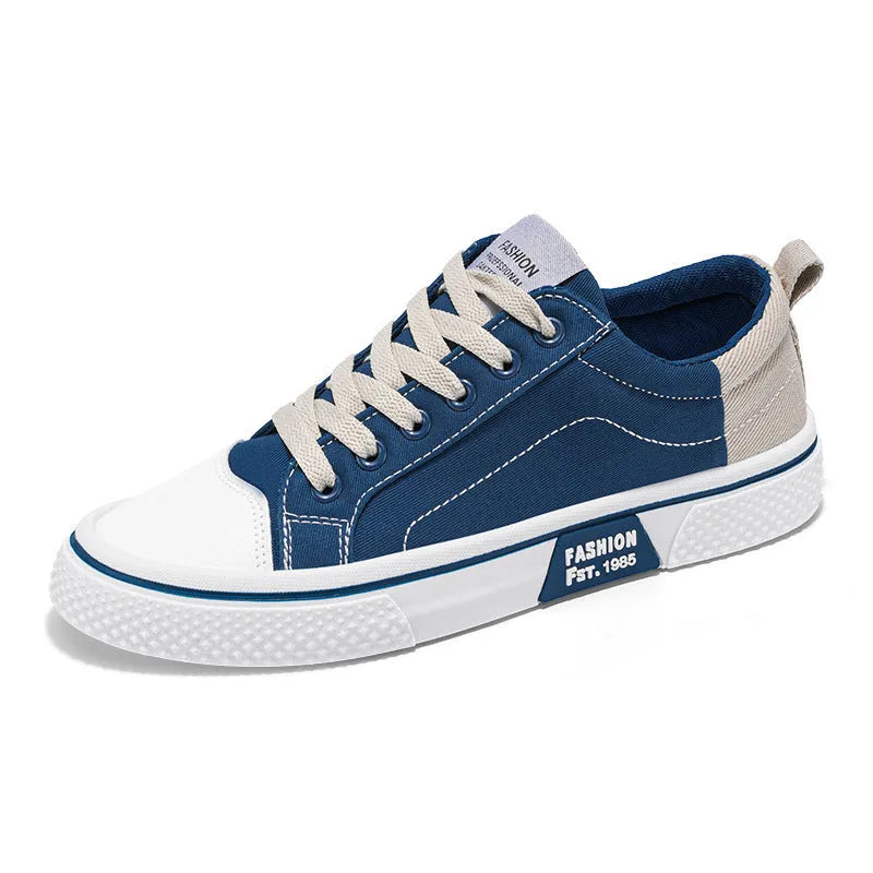 Men's blue low-top canvas skateboard shoes with round toe and white lace-up front.