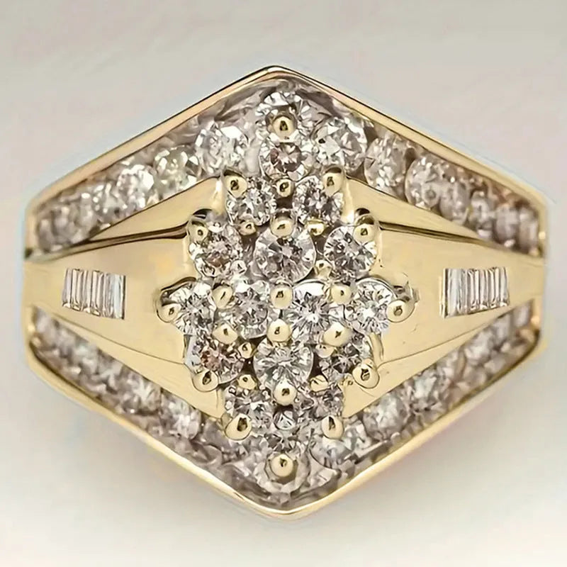 Geometric gold-coloured palace style fashion ring on a plain background, showing its angular design.