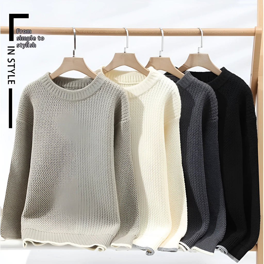 Man wearing a grey loose-fit round neck knitwear pullover sweater for casual autumn wear.